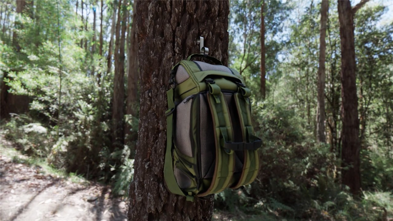 Backpack hanging from a barqHook on a forest tree trunk