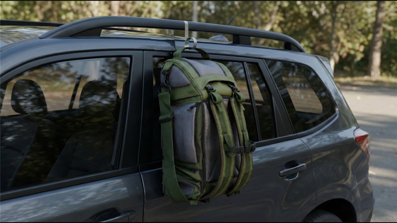 Backpack hanging from a barqHook on an SUV roof rack